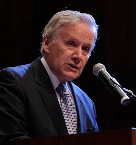 Charles Wise speaking into microphone.