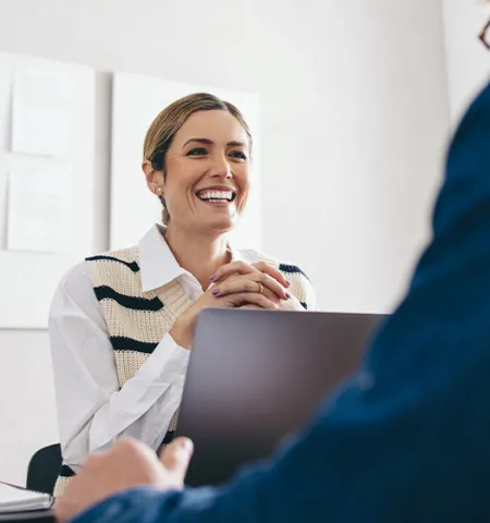 Cheerful businesswoman having a meeting with a business partner in her office (Credit: AdobeStock.com)