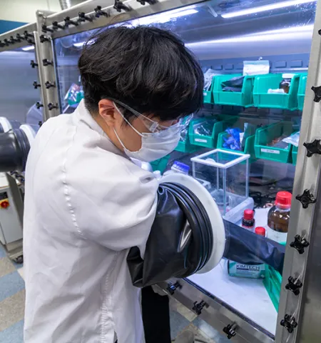 An Ohio State student researcher works at a glovebox at the Energy Innovation Lab at Nanotech West Lab.