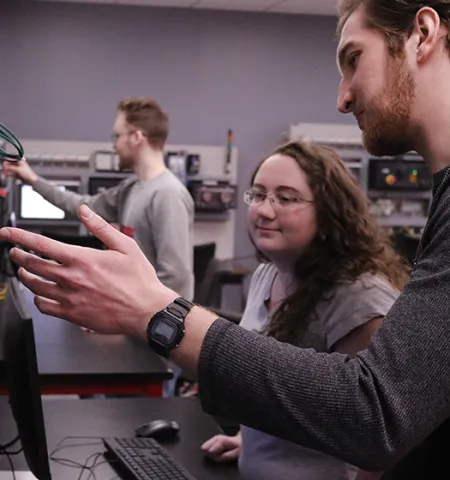 Ohio State University Mansfield senior engineering technology student Sam Ratvasky discusses a project with fellow student Amanda Becker in the industrial automation lab. Ratvasky is now using that knowledge in designing a manufacturing exhibit for a local museum.