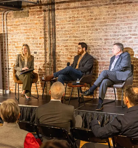 John Glenn College of Public Affairs Associate Professor Amanda Girth, left, sits on a stage with leads with panelists Adam Meyers of CrowdStrike (center) and Scott Deutchman of Google
