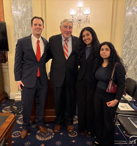 Standing inside a Senate room are Faculty Emeritus Ned Hill, second from left, and Glenn College Washington Academic Internship Program students (from left) Tyler Zachry, political science; Sharika Thaploo, international relations and diplomacy; and Sarika Soni, public policy analysis.