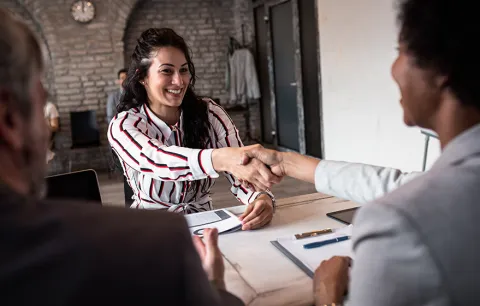 a person shaking hands with an interviewer